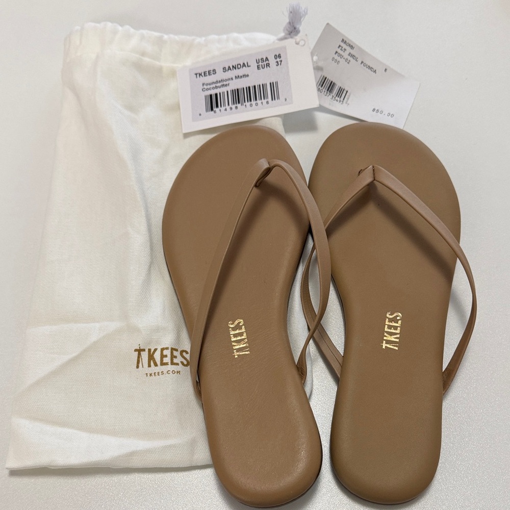New never worn TKEES flip flops in brown.